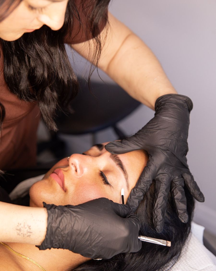Vicki applying brow tint to a client